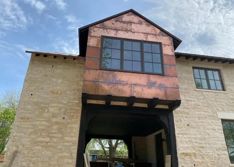 Copper metal panel facade on a stone building for Roof Repair in Blackfoot